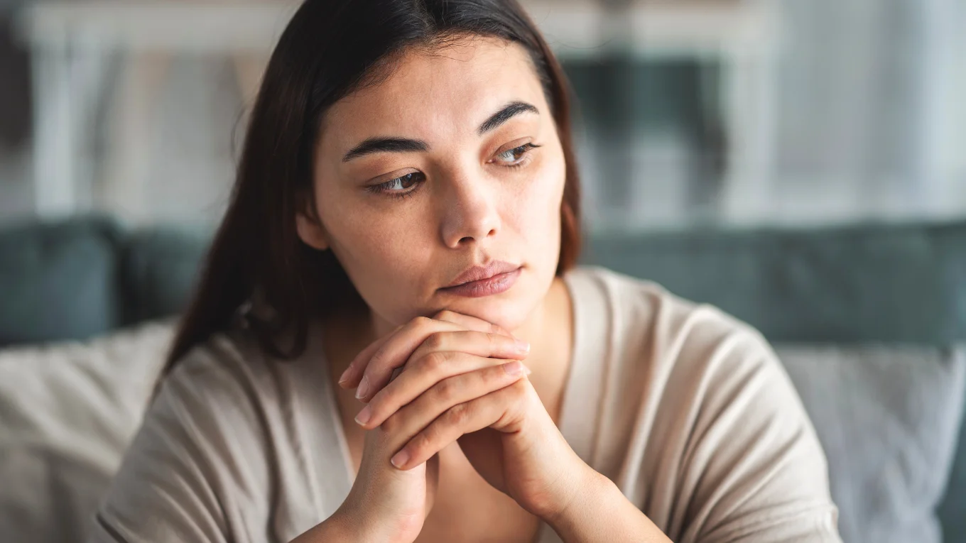 Slightly tired woman reflecting on her fertility health